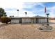 Single story home with grey roof and desert landscaping at 10377 W White Mountain Rd, Sun City, AZ 85351