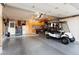 Spacious garage with golf cart and abundant storage at 10377 W White Mountain Rd, Sun City, AZ 85351