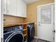 Laundry room with washer, dryer, and ample counter space at 10377 W White Mountain Rd, Sun City, AZ 85351