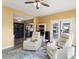 Bright living room with two recliners and access to the kitchen at 10377 W White Mountain Rd, Sun City, AZ 85351