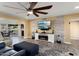 Living room features a stone wall, fireplace, and large TV at 10377 W White Mountain Rd, Sun City, AZ 85351