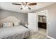 Neutral bedroom featuring a queen bed, ceiling fan, and an entrance to another room at 10433 E Boise St, Apache Junction, AZ 85120