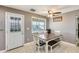 Bright dining area featuring a table with chairs and a bench, ceiling fan, and an exterior door at 10433 E Boise St, Apache Junction, AZ 85120