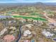 Expansive aerial view showcasing a luxury community bordering a golf course and desert landscape at 10712 E Prospect Point Dr, Scottsdale, AZ 85262