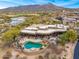 Luxury home with beautiful mountain views featuring a covered patio, outdoor kitchen, and swimming pool at 10712 E Prospect Point Dr, Scottsdale, AZ 85262