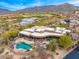 Expansive home with pool, covered patio, and desert landscaping, nestled against a mountain backdrop at 10712 E Prospect Point Dr, Scottsdale, AZ 85262