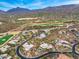 Panoramic aerial view of a luxury community featuring a golf course and stunning mountain backdrop at 10712 E Prospect Point Dr, Scottsdale, AZ 85262