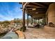 Backyard area with stone flooring, lounge chairs, spa and lush desert landscape at 10712 E Prospect Point Dr, Scottsdale, AZ 85262