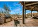 Charming backyard with a built-in grill, comfortable seating, and a tranquil water feature at 10712 E Prospect Point Dr, Scottsdale, AZ 85262