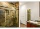 Modern bathroom with a glass shower featuring mosaic tile and a sleek vanity with a modern mirror at 10712 E Prospect Point Dr, Scottsdale, AZ 85262