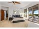 Spacious primary bedroom with a ceiling fan, sliding doors leading to a patio, and ensuite bathroom at 10712 E Prospect Point Dr, Scottsdale, AZ 85262