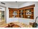 Inviting den with built-in wooden bookshelves, patterned floors, and comfortable seating at 10712 E Prospect Point Dr, Scottsdale, AZ 85262