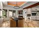 Elegant dining room with modern chandelier, fireplace, wet bar, and views of outdoor scenery at 10712 E Prospect Point Dr, Scottsdale, AZ 85262