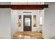 Elegant entrance foyer with stone tile flooring, a wrought-iron door, and bright white walls at 10712 E Prospect Point Dr, Scottsdale, AZ 85262