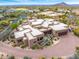 Exterior of a large home featuring Southwestern architecture, manicured desert landscaping, and a brick driveway at 10712 E Prospect Point Dr, Scottsdale, AZ 85262