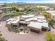 View of a Southwestern-style home with desert landscaping, a circular driveway, and attached garages at 10712 E Prospect Point Dr, Scottsdale, AZ 85262