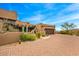 Front view of Southwestern-style home with brick driveway, desert landscaping, and an attached garage at 10712 E Prospect Point Dr, Scottsdale, AZ 85262