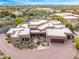 A spacious, Southwestern home is enhanced by drought-tolerant landscaping and a curved driveway at 10712 E Prospect Point Dr, Scottsdale, AZ 85262