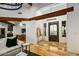 Open foyer with high ceilings, wood beams, modern light fixture and view into the dining room at 10712 E Prospect Point Dr, Scottsdale, AZ 85262