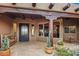 Welcoming front entrance with a stone pathway, decorative cacti, and a wrought iron door at 10712 E Prospect Point Dr, Scottsdale, AZ 85262