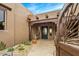 Inviting front entrance featuring a stone path, rustic accents, and a charming arched gate at 10712 E Prospect Point Dr, Scottsdale, AZ 85262