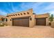 Image of a garage featuring Southwestern architectural elements with two dark wood doors at 10712 E Prospect Point Dr, Scottsdale, AZ 85262