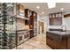 Gourmet kitchen featuring a stainless steel stove and hood, and a glass encased wine cellar at 10712 E Prospect Point Dr, Scottsdale, AZ 85262