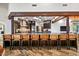 Open kitchen design featuring a large bar, stainless steel appliances, and wood beam accents at 10712 E Prospect Point Dr, Scottsdale, AZ 85262