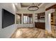 Light-filled living area with travertine flooring, a wet bar, and views of the desert landscape at 10712 E Prospect Point Dr, Scottsdale, AZ 85262