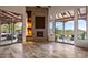 Open living room with a stone fireplace, built-in shelves, a wall of sliding glass doors leading to the patio at 10712 E Prospect Point Dr, Scottsdale, AZ 85262