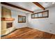 Cozy living space with a fireplace, exposed beams and shuttered windows at 10712 E Prospect Point Dr, Scottsdale, AZ 85262