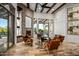 Cozy living room with stone fireplace, beamed ceilings, and large windows overlooking the yard at 10712 E Prospect Point Dr, Scottsdale, AZ 85262