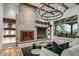 Living room features stone fireplace, built-in shelving, modern lighting, and comfortable seating at 10712 E Prospect Point Dr, Scottsdale, AZ 85262