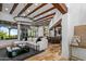 Open-concept living room with travertine floors, wood beam ceiling, and elegant furniture at 10712 E Prospect Point Dr, Scottsdale, AZ 85262