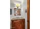 Stylish powder room featuring a unique vanity with a decorative mirror and rustic accents at 10712 E Prospect Point Dr, Scottsdale, AZ 85262