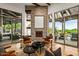 Cozy sitting area with a stone fireplace and access to outdoor living spaces at 10712 E Prospect Point Dr, Scottsdale, AZ 85262