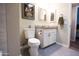 Bathroom features a granite countertop and a decorative framed tulip art piece hanging above the toilet at 10906 W Boswell Blvd, Sun City, AZ 85373