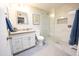 Bathroom featuring glass shower, granite counters and a stylish framed art piece hanging above the toilet at 10906 W Boswell Blvd, Sun City, AZ 85373