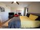 Bedroom featuring a ceiling fan, a bed, wood-look flooring, and natural light from two windows at 10906 W Boswell Blvd, Sun City, AZ 85373