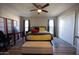 Bedroom featuring a ceiling fan, neutral walls, wood-look flooring, and ample closet space at 10906 W Boswell Blvd, Sun City, AZ 85373