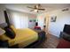 Cozy bedroom with ceiling fan, wood-look flooring, a comfortable bed, and white closets at 10906 W Boswell Blvd, Sun City, AZ 85373