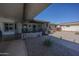 Spacious, covered front porch and gate, with desert landscaping, offering privacy and shade at 10906 W Boswell Blvd, Sun City, AZ 85373