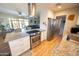 Modern kitchen with stainless steel appliances, white cabinetry, a large range hood, and granite countertops at 10906 W Boswell Blvd, Sun City, AZ 85373