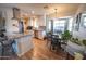 Modern kitchen with white cabinets, granite countertops, stainless steel appliances, and adjacent dining area at 10906 W Boswell Blvd, Sun City, AZ 85373