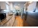 Bright kitchen featuring white cabinets, stainless steel appliances, granite countertops, and wood-look flooring at 10906 W Boswell Blvd, Sun City, AZ 85373