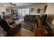 Comfortable living room featuring plush seating and a large area rug over wood-look floors at 10906 W Boswell Blvd, Sun City, AZ 85373