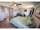 Bright main bedroom with an ensuite bathroom, wood-look floors, ceiling fan and abundant natural light at 10906 W Boswell Blvd, Sun City, AZ 85373