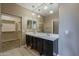 Bathroom with double sink vanity, tile floors and mirrored cabinets at 1203 E Judi St, Casa Grande, AZ 85122