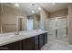 Bathroom with double vanity, tile floors and glass enclosed shower stall at 1203 E Judi St, Casa Grande, AZ 85122