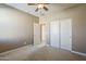 Bedroom featuring neutral carpet, fresh paint, a ceiling fan, and closet for ample storage at 1203 E Judi St, Casa Grande, AZ 85122